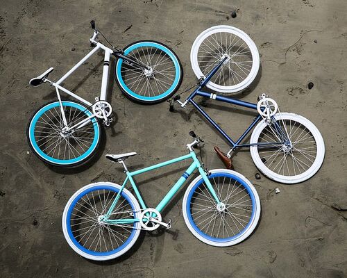 three-road-bikes-on-gray-pavement