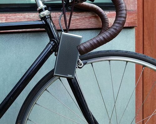 gray-and-black-road-bike-leaning-on-brown-and-gray-concrete-wall
