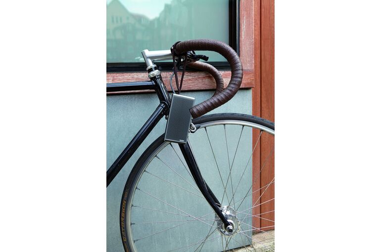 gray-and-black-road-bike-leaning-on-brown-and-gray-concrete-wall